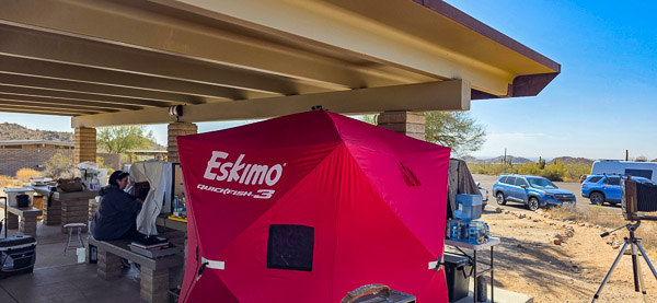 Student at the darkbox, Someone inside the ice fishing tent darkroom